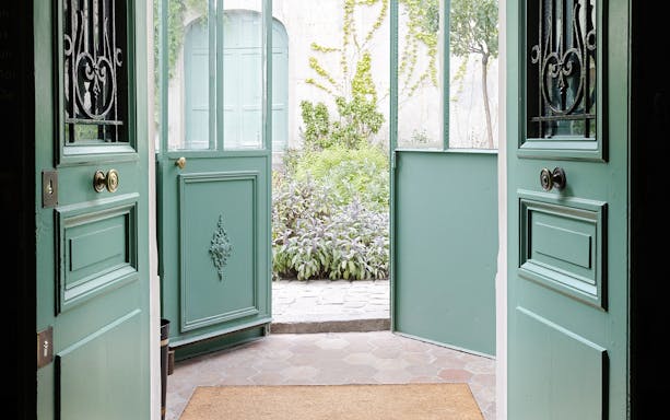Open doors leading to a garden courtyard at Maison de Balzac, Paris.
