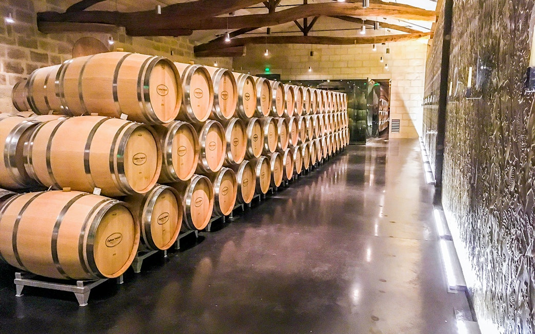 Wine barrels in a cellar during a Saint-Emilion Grand Cru tour.
