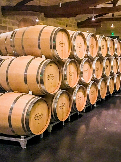 Wine barrels in a cellar during a Saint-Emilion Grand Cru tour.