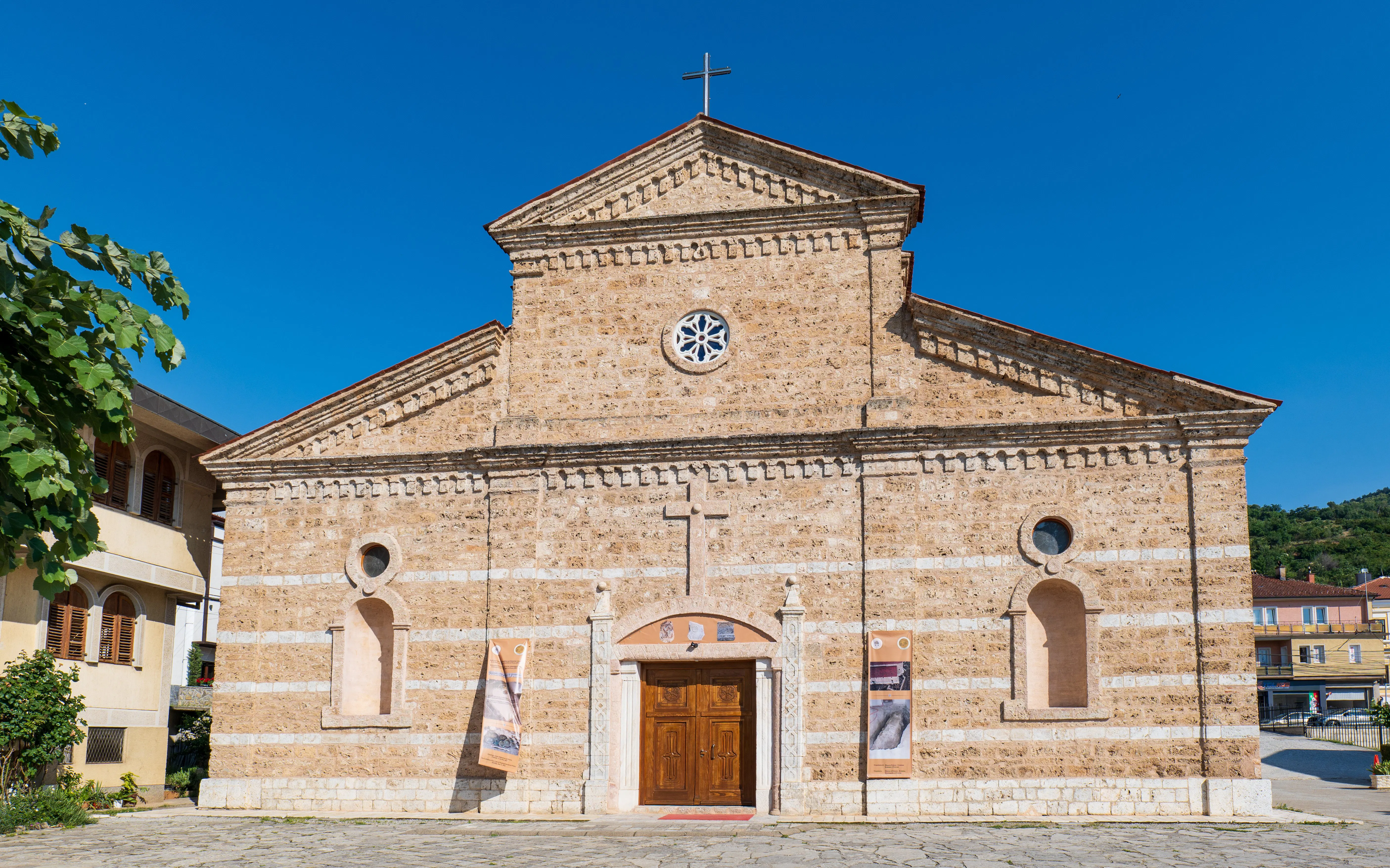 Catholic church facade in Prizren, Kosovo with stone architecture and wooden doors.