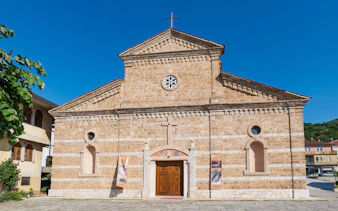 Catholic church facade in Prizren, Kosovo with stone architecture and wooden doors.