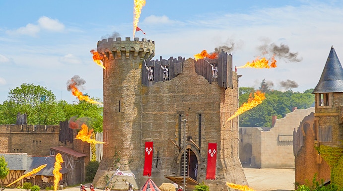Medieval castle show with fire effects at Puy du Fou, France.
