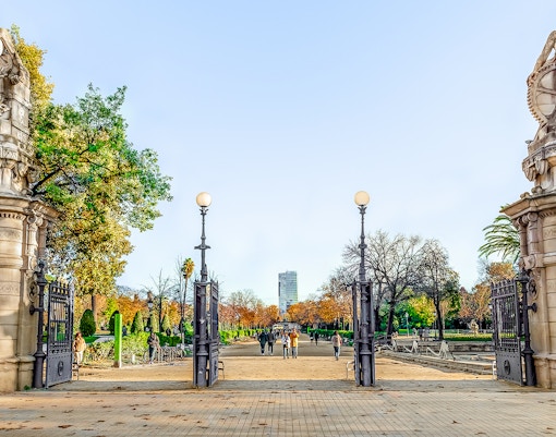 Ciutadella Park entrance gate with statues and pathway in Barcelona.