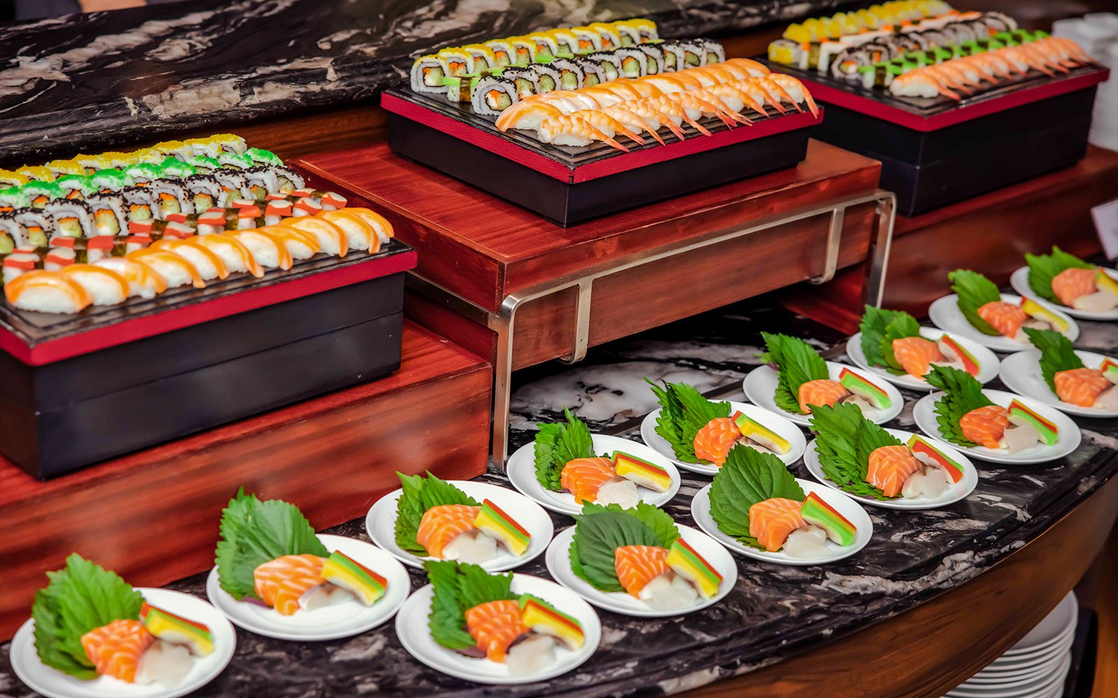 Sushi platter buffet on Ambassador cruise with assorted rolls and sashimi.