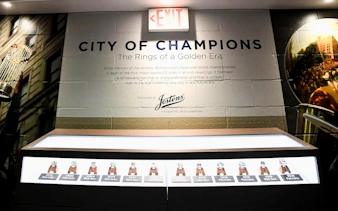 Exhibit of championship rings at The Sports Museum, Boston, showcasing Boston teams' victories.
