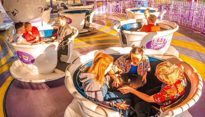 Guests enjoying a teacup ride at Thorpe Park London.
