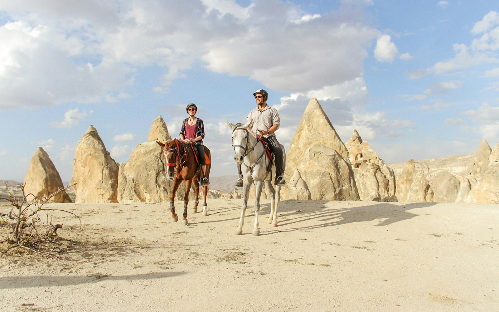 Horseback riders in Cappadocia's unique rock formations during a 2-hour tour.