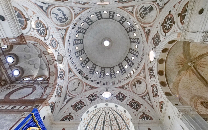 Dome interior of Santa Maria delle Grazie, Milan, featuring intricate frescoes and architectural details.
