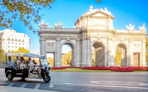 Eco Tuk Tuk tour in Lisbon, Portugal, showcasing vibrant city streets and historic architecture.