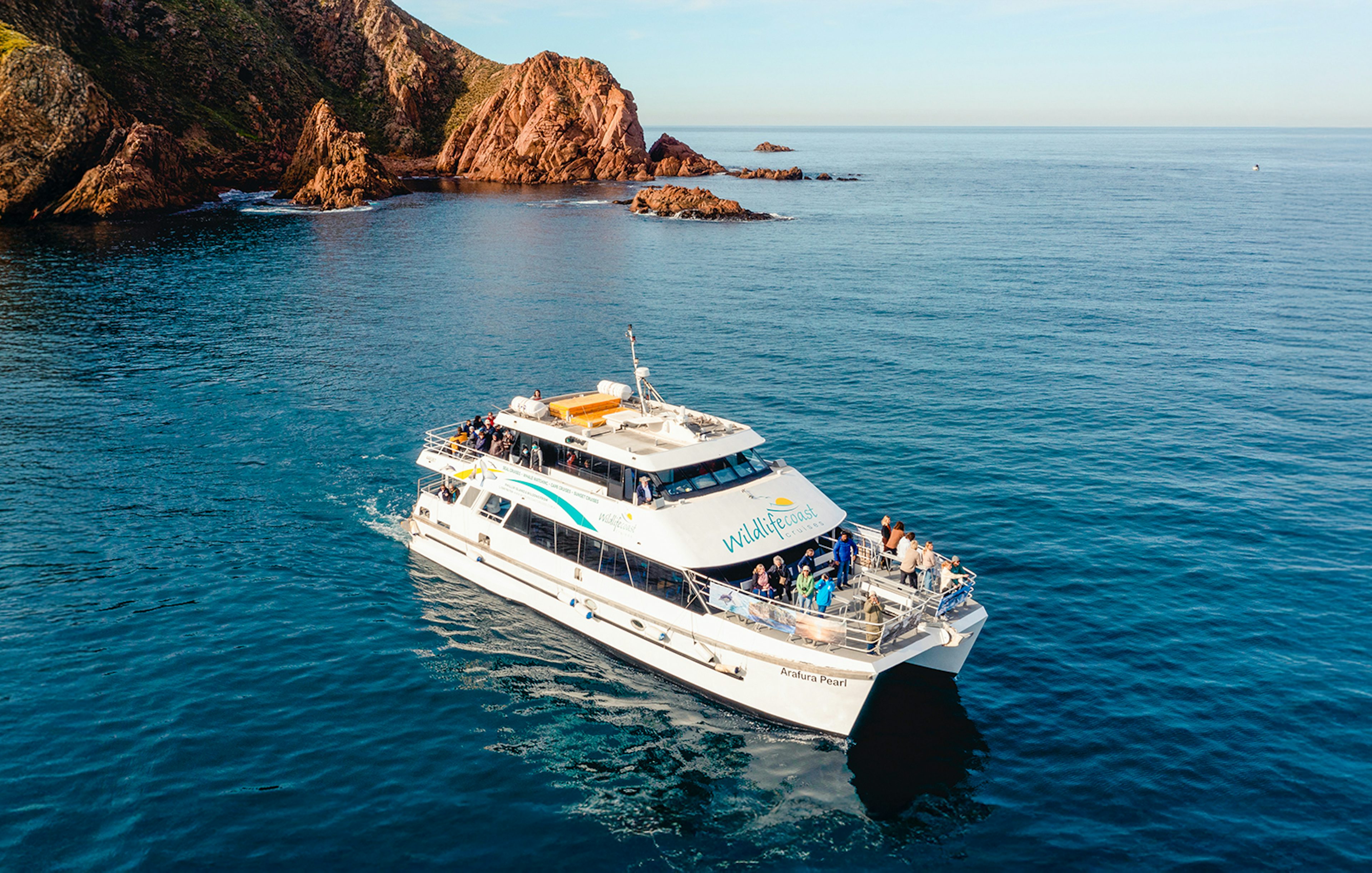 Cruise boat near Cape Woolamai, Phillip Island, with passengers enjoying Wildlife Coast Cruises.