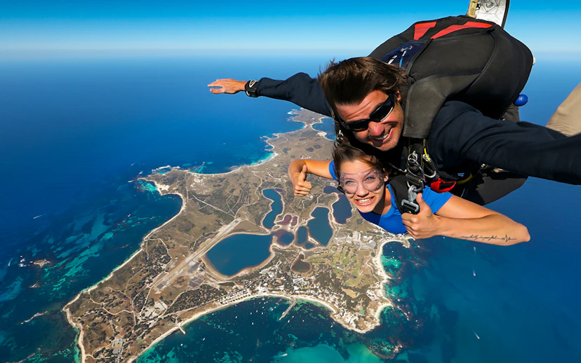Tandem skydive over Rottnest Island, Perth, with aerial view of coastline and landscape below.