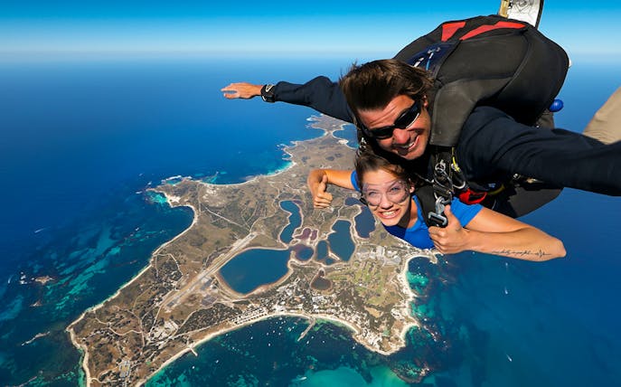 Tandem skydive over Rottnest Island, Perth, with aerial view of coastline and landscape below.