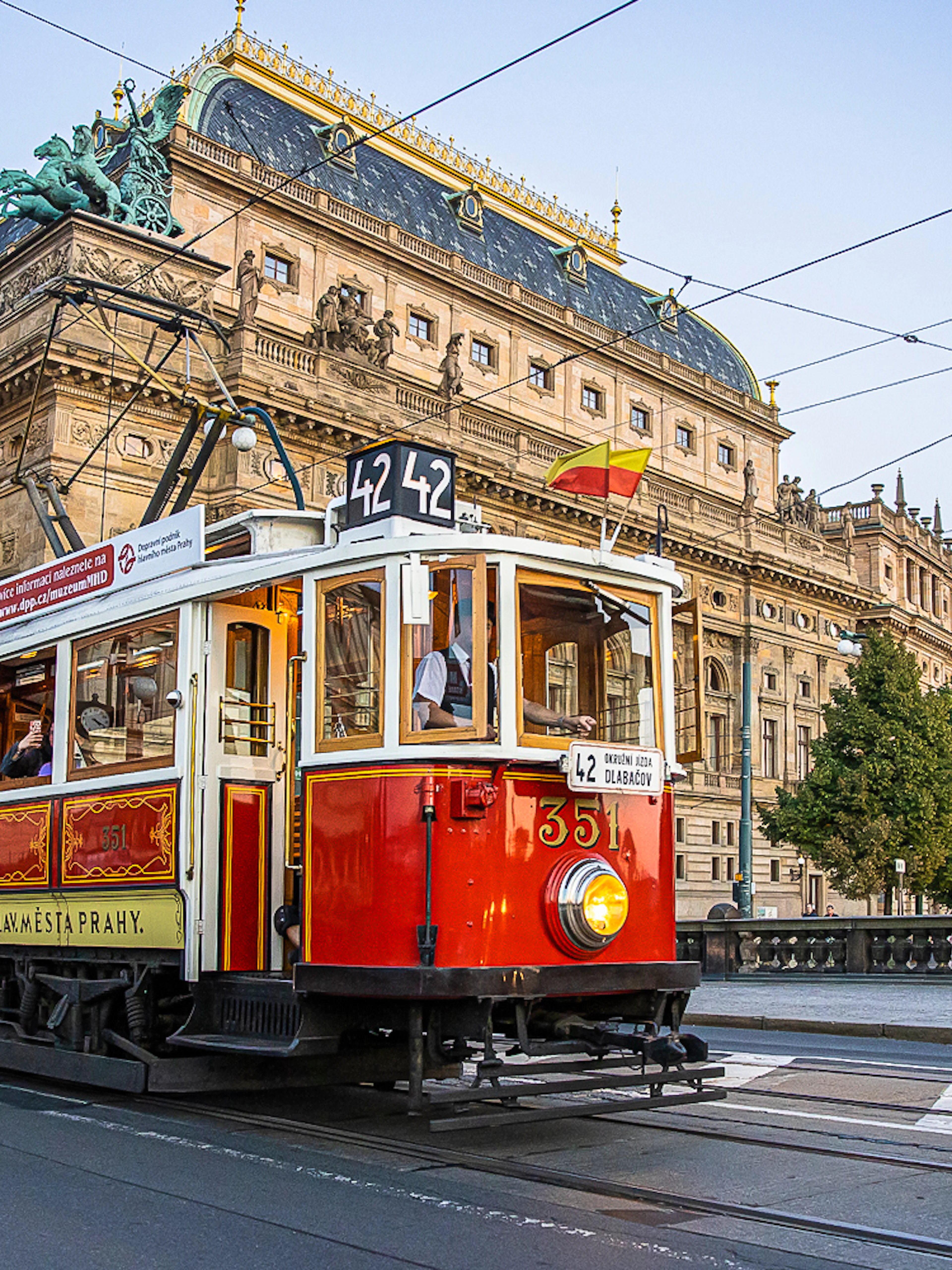 Prague tram passing by the National Theatre on a hop-on hop-off tour.
