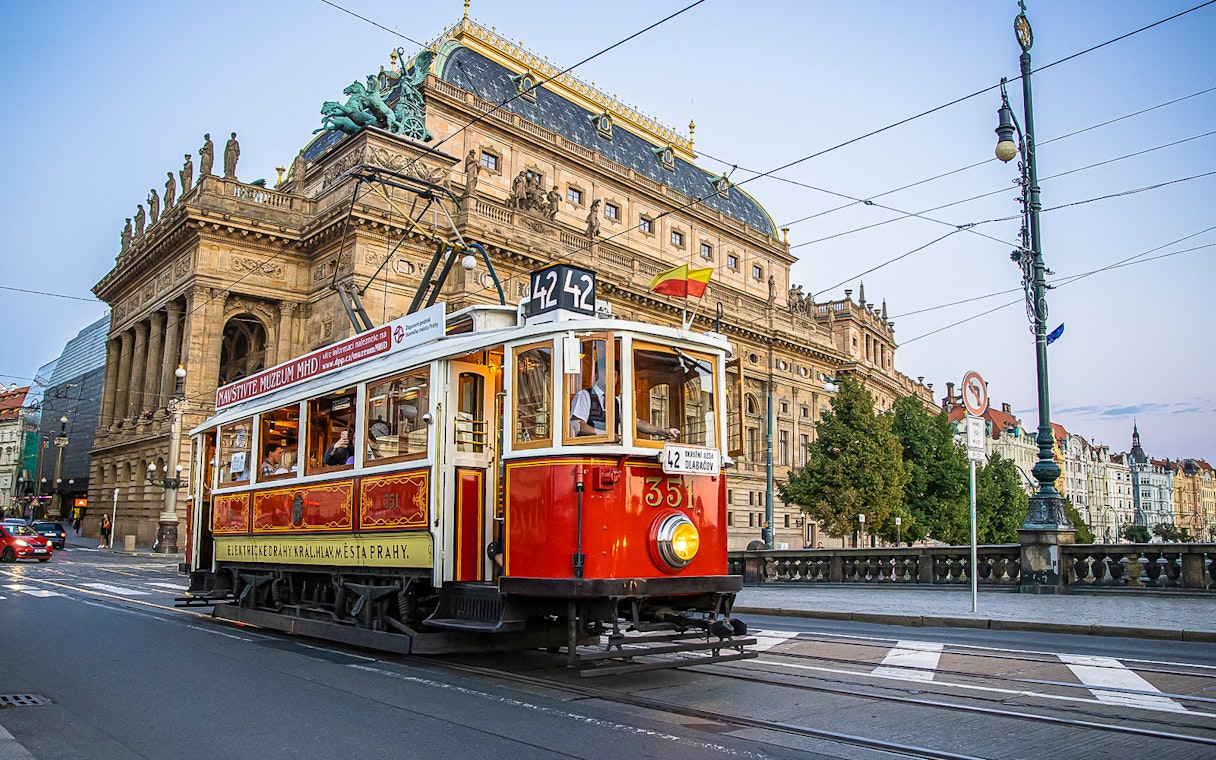 Prague tram passing by the National Theatre on a hop-on hop-off tour.