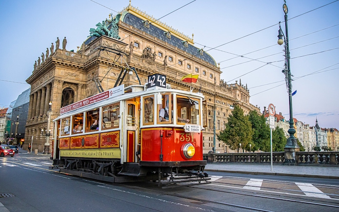 Prague tram passing by the National Theatre on a hop-on hop-off tour.