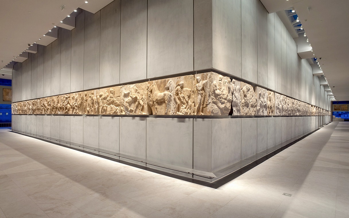 Acropolis Museum frieze display in Athens, Greece, showcasing ancient Greek sculptures.