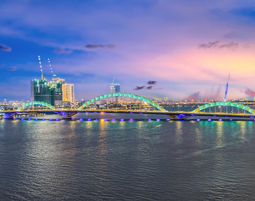 Fire Breathing Dragon Bridge at Da Nang over a river, wonderful colours of the Sky at night and river in Da Nang Vietnam