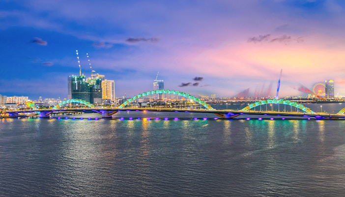 Fire Breathing Dragon Bridge at Da Nang over a river, wonderful colours of the Sky at night and river in Da Nang Vietnam
