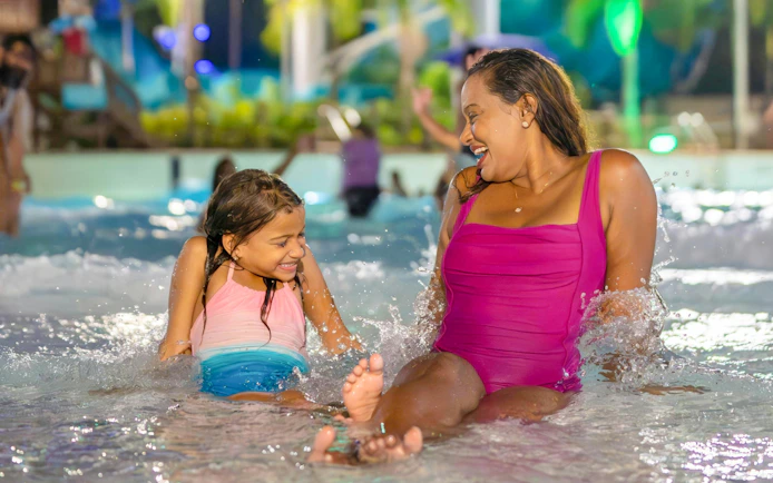 Mother and daughter enjoying AquaGlow event at Aquatica San Antonio water park.