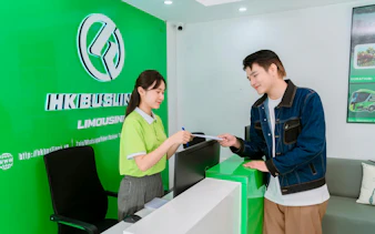 Reception desk at HK Buslines in Hanoi for Sapa–Hanoi–Noi Bai Airport shuttle transfer.