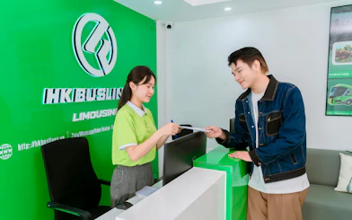 Reception desk at HK Buslines in Hanoi for Sapa–Hanoi–Noi Bai Airport shuttle transfer.