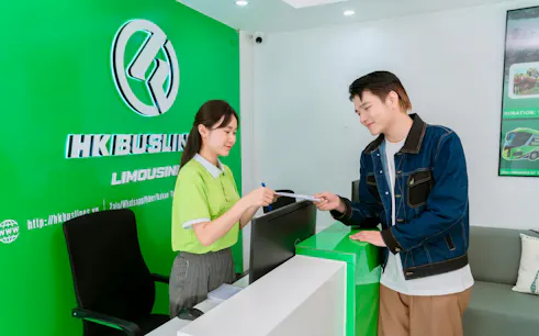 Reception desk at HK Buslines in Hanoi for Sapa–Hanoi–Noi Bai Airport shuttle transfer.