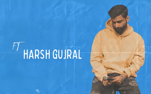 Stand-up comedian holding a microphone, featuring Harsh Gujral.