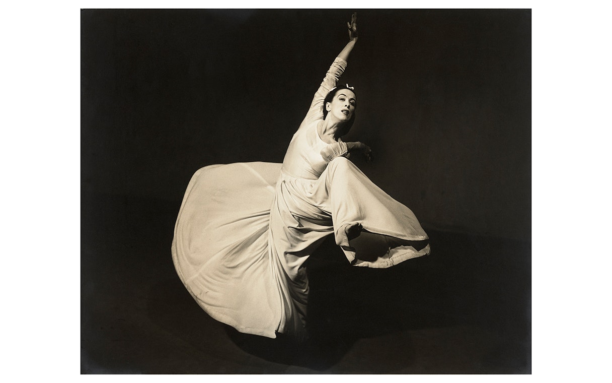 Dancer in flowing dress captured mid-movement, featured in Women Photographers (1900-1975) at National Gallery of Victoria.