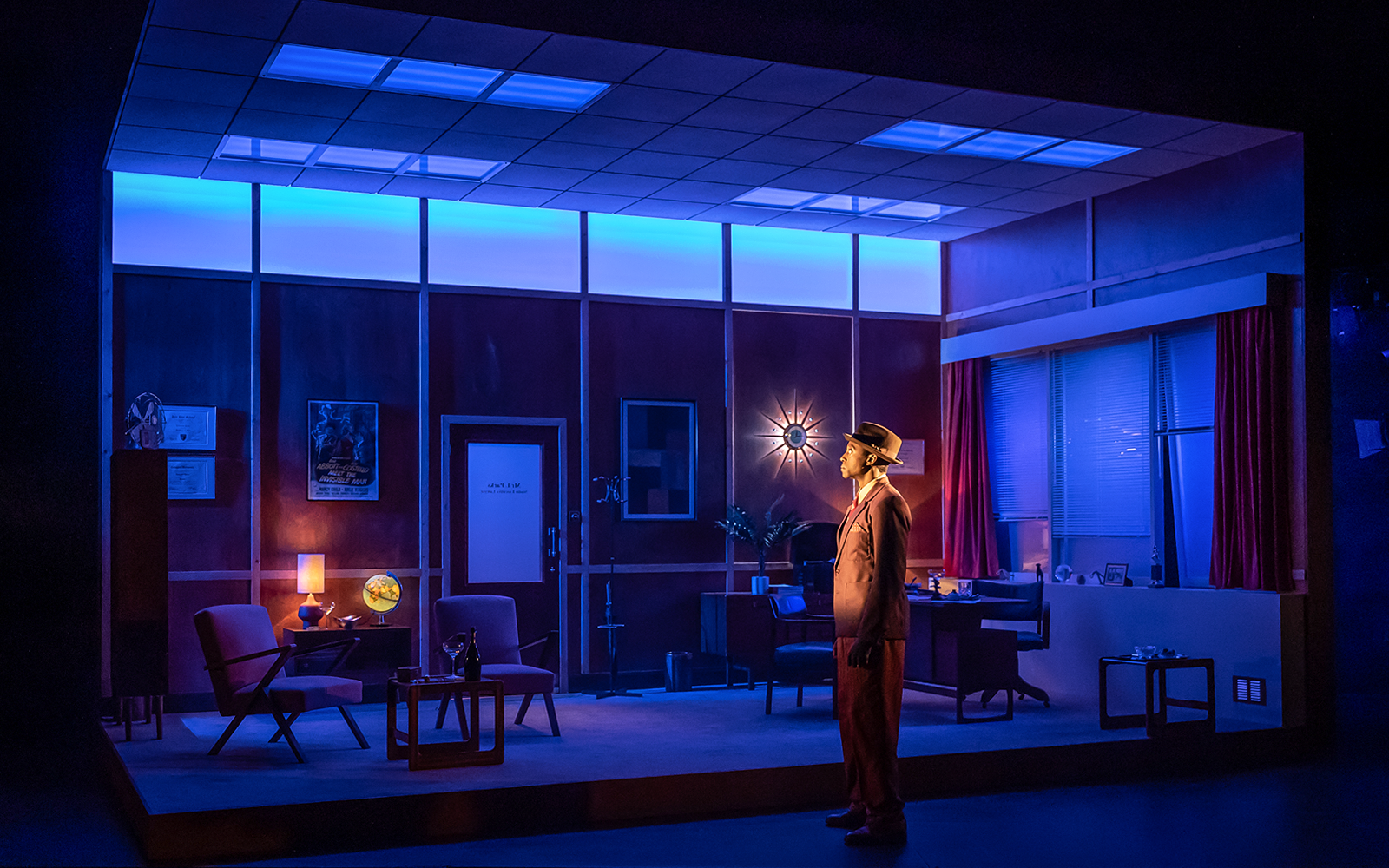 Man in vintage office setting with blue lighting, related to Retrograde tour.