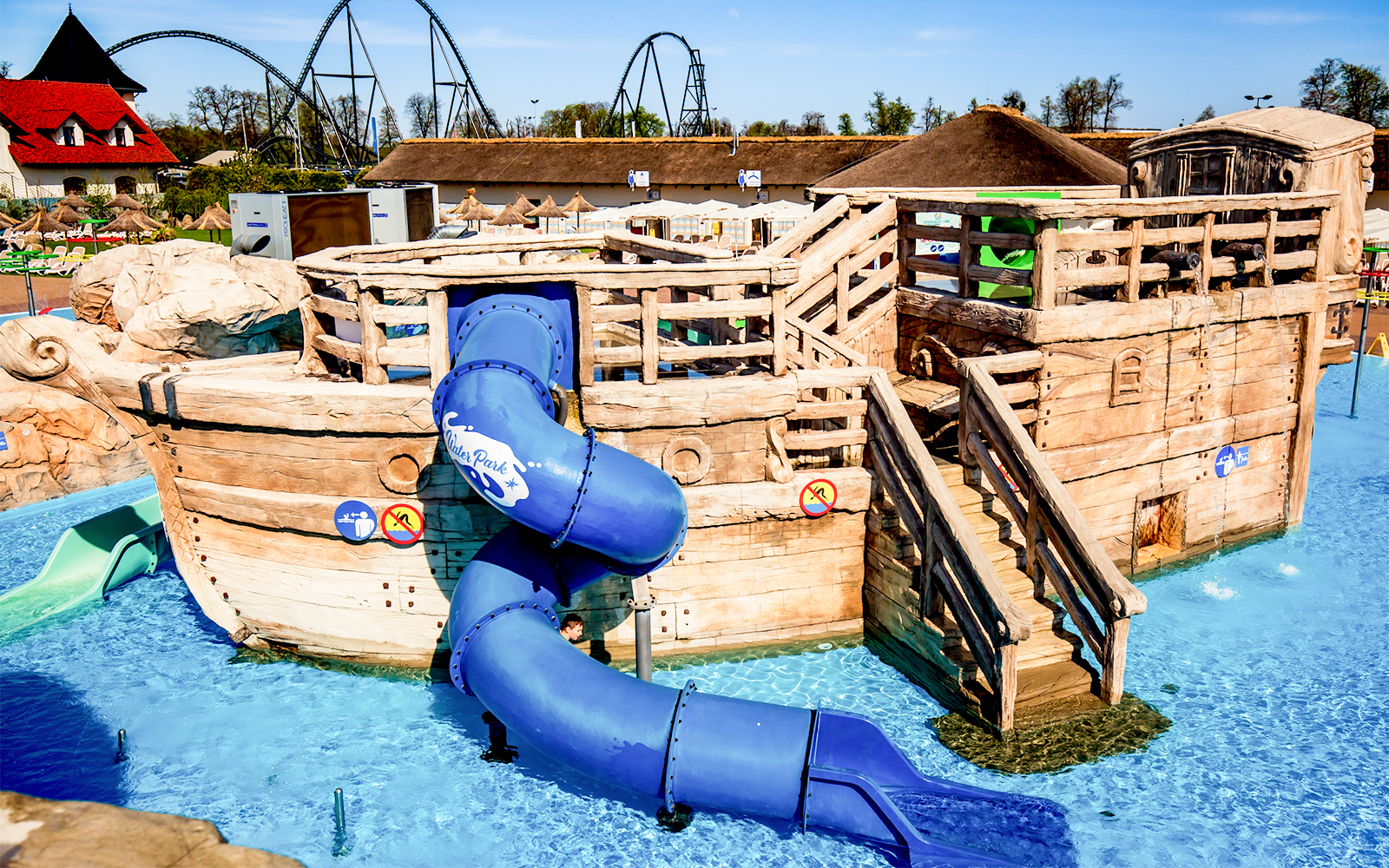 Wooden pirate ship with blue slide at Poland's largest open-air water park in Energylandia, Zator.