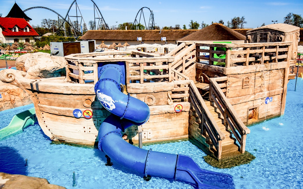 Wooden pirate ship with blue slide at Poland's largest open-air water park in Energylandia, Zator.