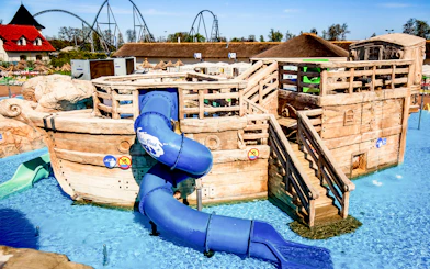 Wooden pirate ship with blue slide at Poland's largest open-air water park in Energylandia, Zator.
