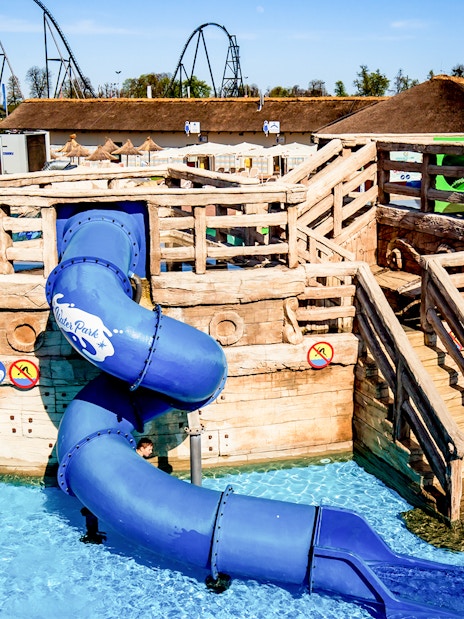 Wooden pirate ship with blue slide at Poland's largest open-air water park in Energylandia, Zator.