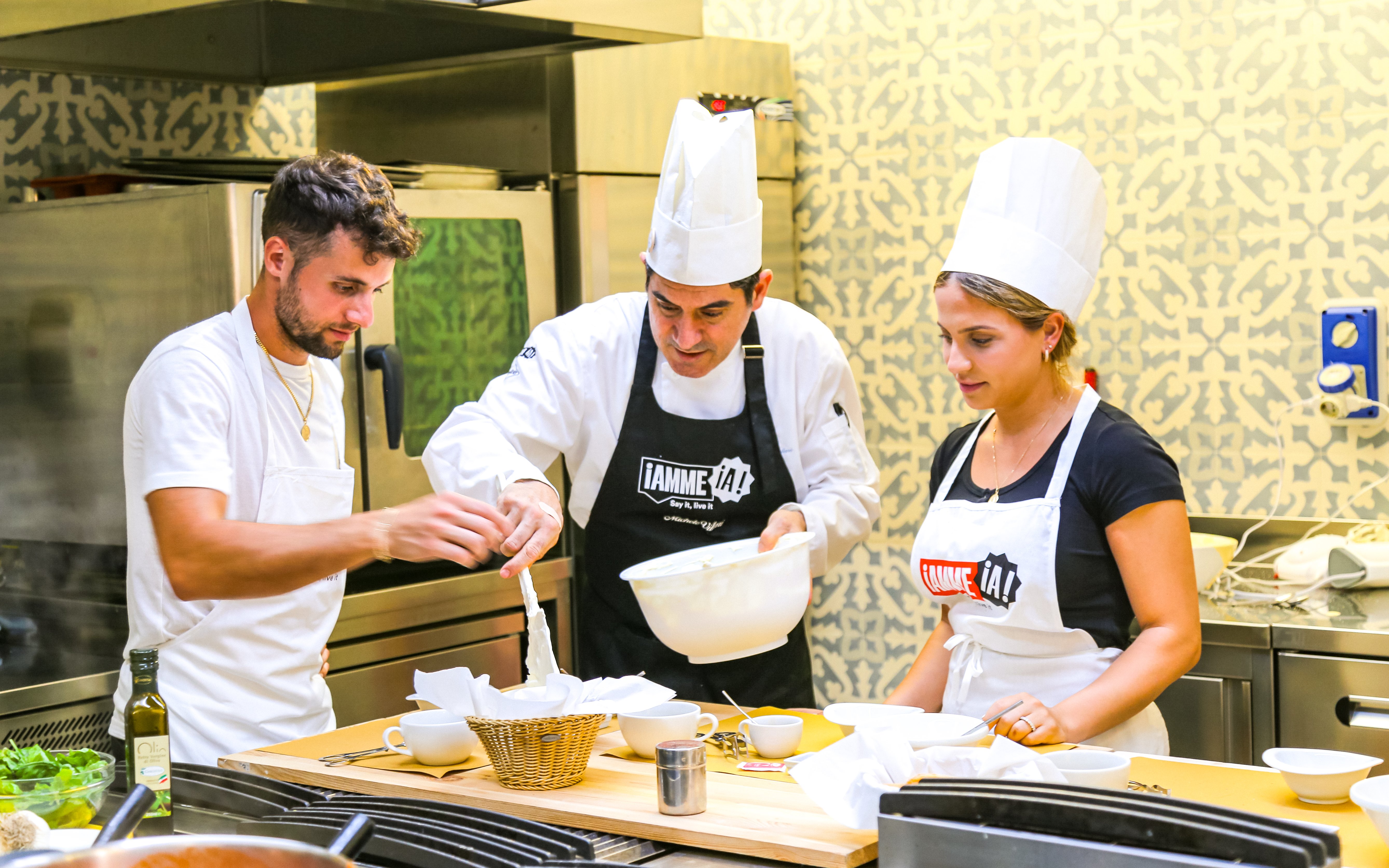 Tourists learning to cook with a chef at Neapolitan Cooking School in Sorrento.