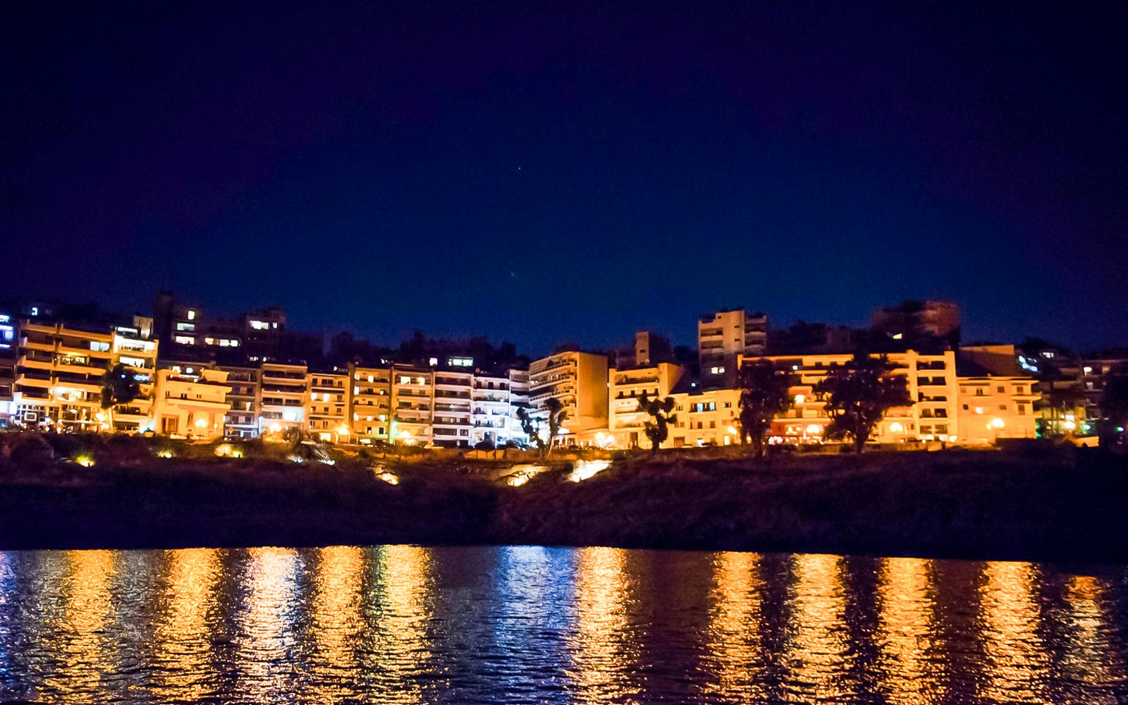 Athens Riviera evening cruise with cityscape and sunset over the Aegean Sea.