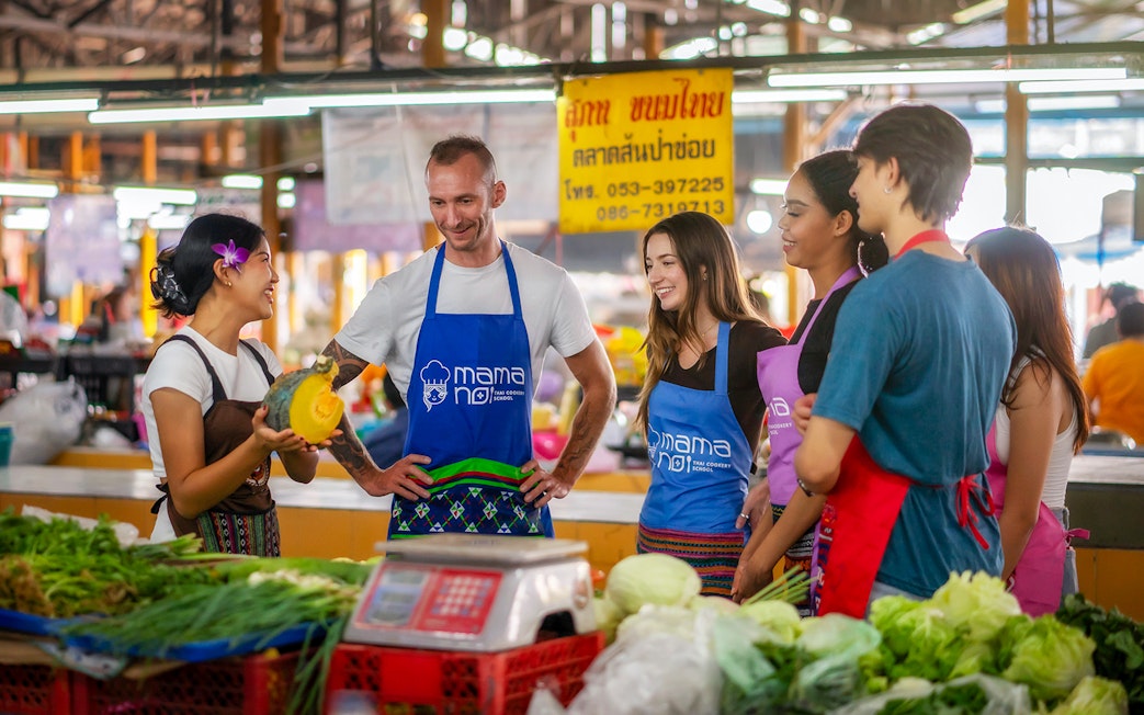 Group learning about local produce at a traditional Thai market in Chiang Mai.