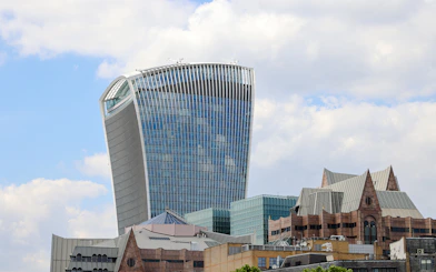 Walkie Talkie building in London, home to Sky Garden, against a cloudy sky.