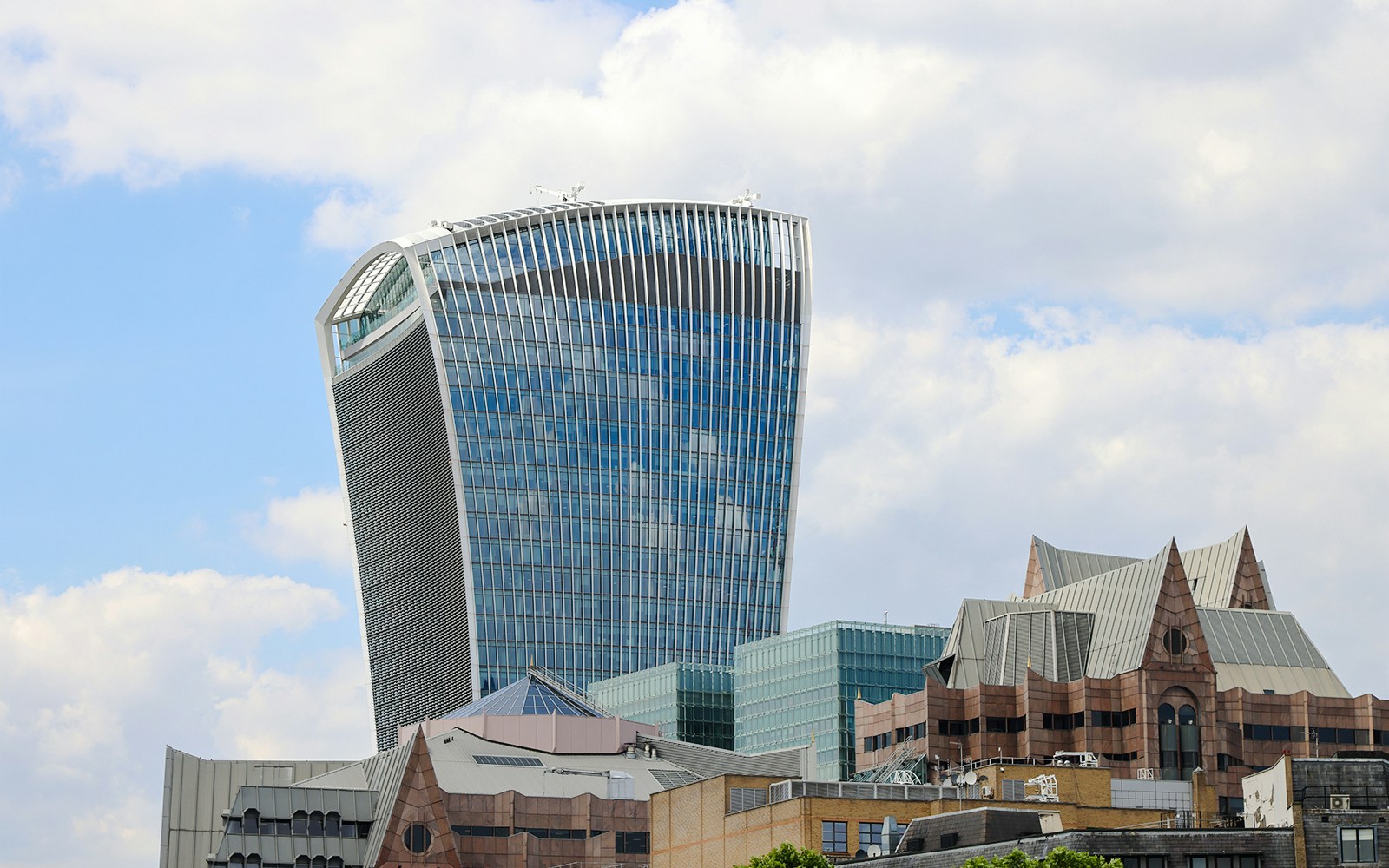 Walkie Talkie building in London, home to Sky Garden, against a cloudy sky.