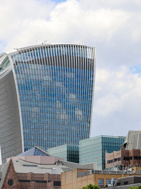 Walkie Talkie building in London, home to Sky Garden, against a cloudy sky.