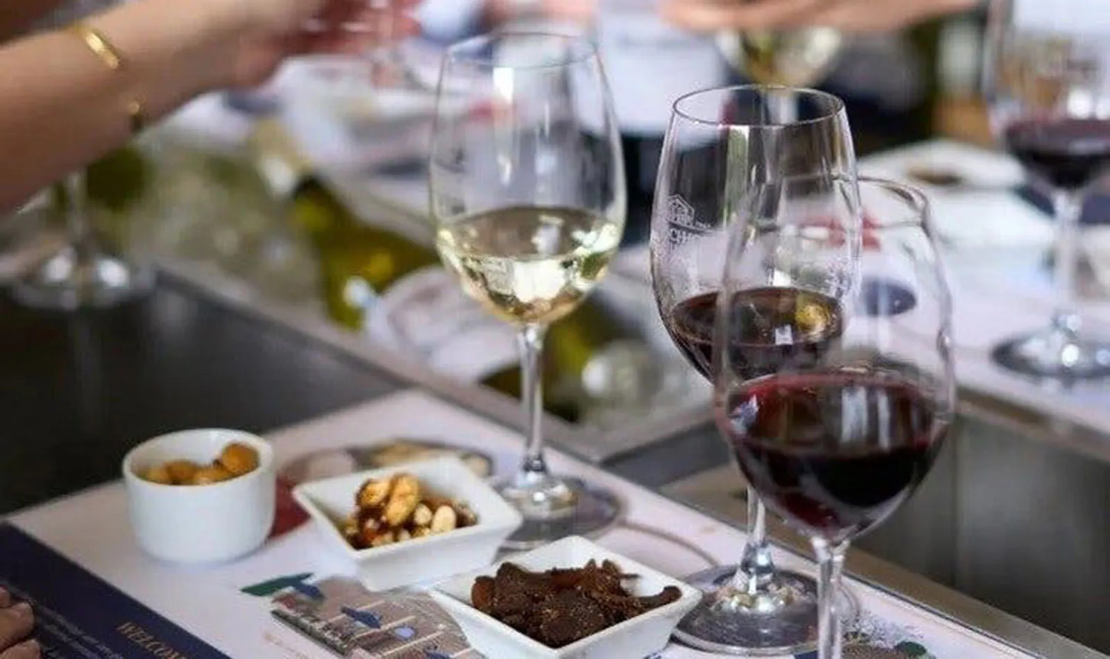 Wine glasses and snacks on a table during a Cape Town wine tour.