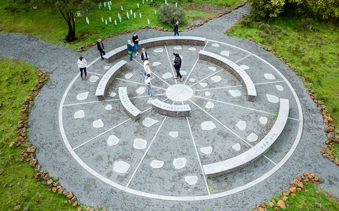 Aerial view of visitors exploring a circular stone installation on the Kooyang Walk Full Day Tour.