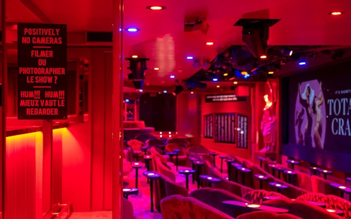 Crazy Horse Cabaret Show seating area with stage and vibrant lighting.