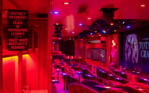 Crazy Horse Cabaret Show seating area with stage and vibrant lighting.