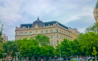 Historic building facade in Budapest, part of the Golden Age Sweet Tastes city exploration game.
