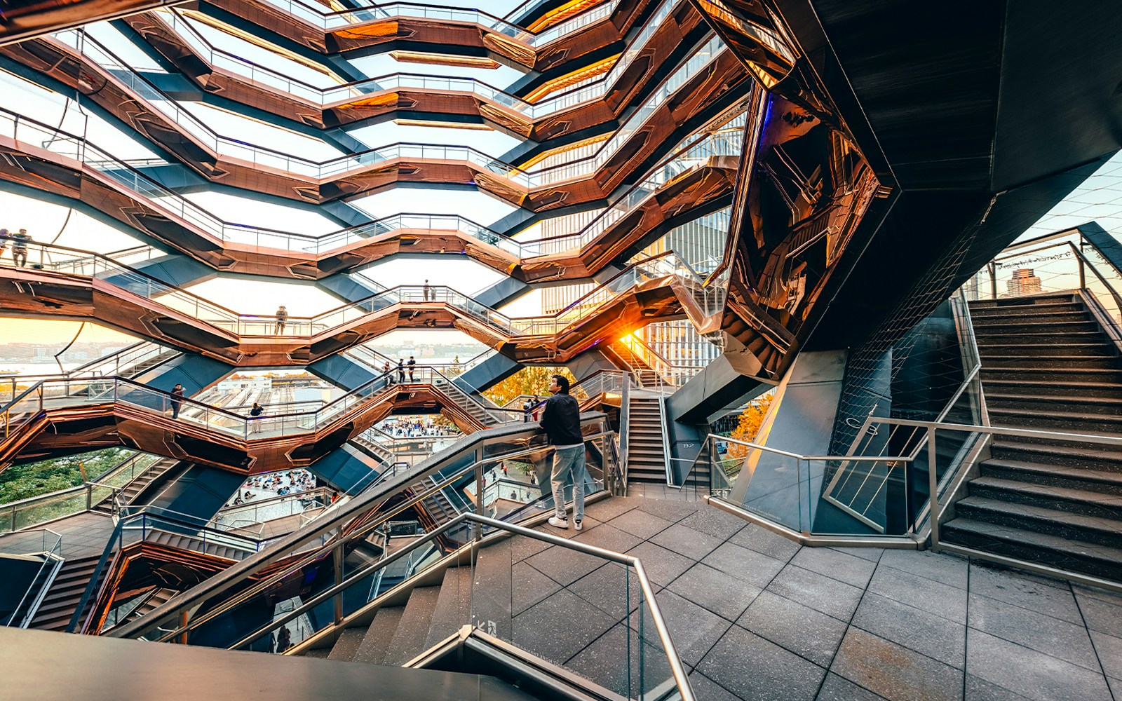 Vessel structure in New York City with visitors on interconnected staircases.