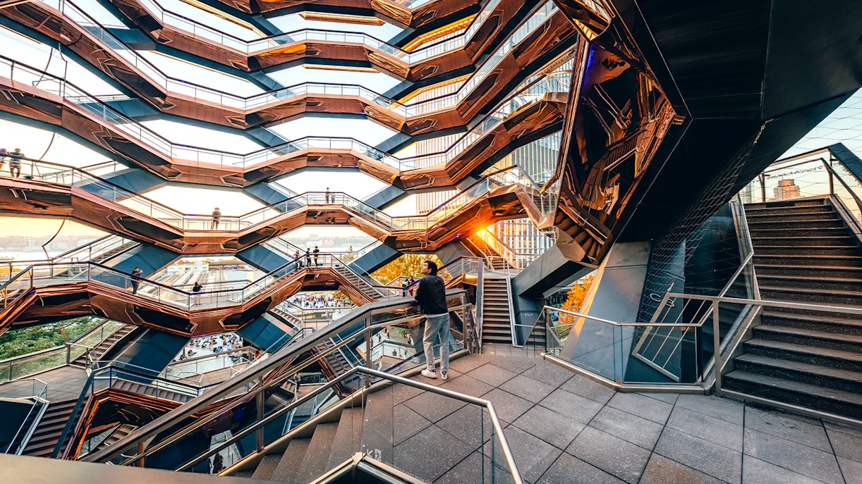 Vessel structure in New York City with visitors on interconnected staircases.