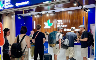 Travelers collecting Bali SIM cards at airport kiosk on arrival.