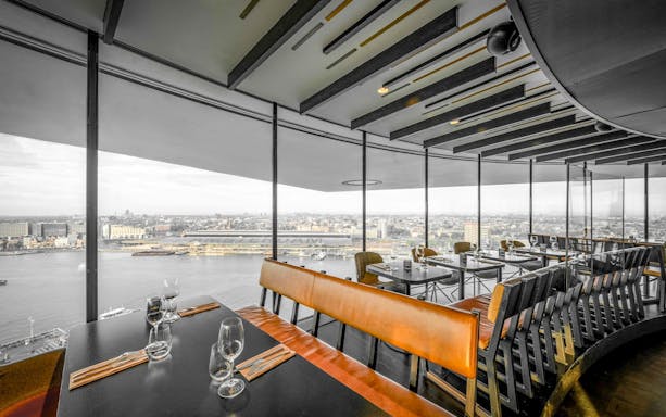 Revolving restaurant Moon with city view and set tables for lunch.