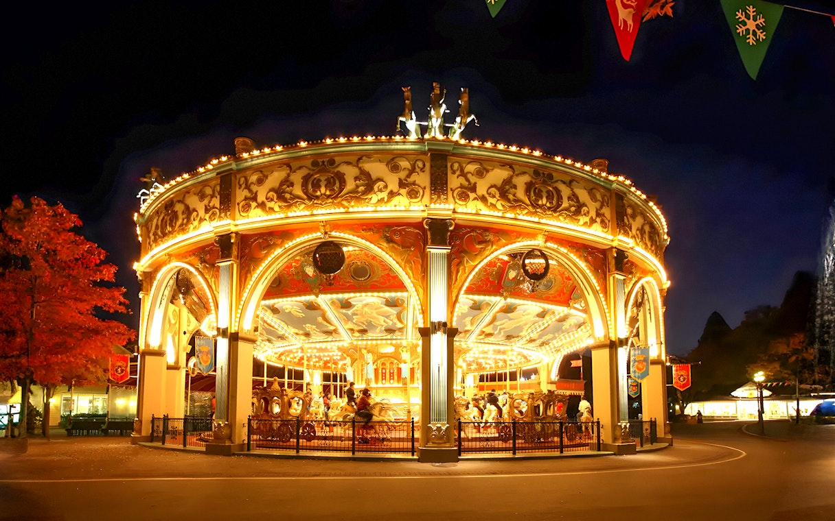 Illuminated carousel at night in Everland theme park, South Korea.