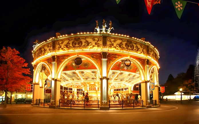 Illuminated carousel at night in Everland theme park, South Korea.